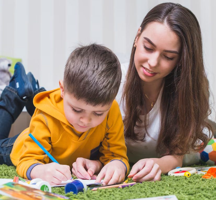 Woman drawing with boy